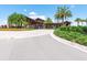 Inviting entrance to the community clubhouse with stone columns, lush landscaping and an inviting circular drive at 15403 Leven Links Pl, Lakewood Ranch, FL 34202