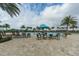 Community pool deck area with a splash pad, lounge chairs, tables and umbrellas, perfect for relaxation at 15403 Leven Links Pl, Lakewood Ranch, FL 34202