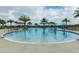 Large zero entry community pool with various water features and shaded lounge areas for relaxing at 15403 Leven Links Pl, Lakewood Ranch, FL 34202