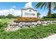 Entrance sign for The Lodge at Lakewood Ranch Golf & Country Club with lush landscaping and bright blue sky at 15403 Leven Links Pl, Lakewood Ranch, FL 34202