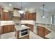Spacious kitchen with granite countertops, a center island, and stainless steel appliances at 15403 Leven Links Pl, Lakewood Ranch, FL 34202