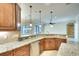 Open kitchen featuring granite counters, stainless steel appliances, and modern pendant lighting at 15403 Leven Links Pl, Lakewood Ranch, FL 34202