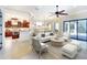 Bright, open-concept living room featuring modern furnishings and a seamless flow to the kitchen and dining area at 15403 Leven Links Pl, Lakewood Ranch, FL 34202