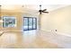 Bright, airy living room featuring tile flooring and sliding glass doors to the outside at 15403 Leven Links Pl, Lakewood Ranch, FL 34202