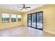 Large living room featuring tile floors, ceiling fan, and access to the backyard at 15403 Leven Links Pl, Lakewood Ranch, FL 34202