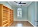 Bright home office with hardwood floors, built-in bookshelves, and a large window at 15403 Leven Links Pl, Lakewood Ranch, FL 34202