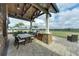Outdoor dining area with stone columns and a built-in grill overlooking a beautiful view at 15403 Leven Links Pl, Lakewood Ranch, FL 34202