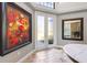 Bright foyer with travertine floors, a table with flowers, and beautiful wall decor at 16748 4Th Ne Ave, Bradenton, FL 34212