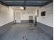The clean garage offers ample space and features a grey painted accent at 1717 Alton Rd, Port Charlotte, FL 33952