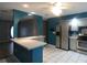 Open kitchen features a tiled floor, stainless steel appliances, granite countertops, and a breakfast bar at 1717 Alton Rd, Port Charlotte, FL 33952