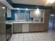 Well-lit kitchen with stainless steel appliances and a sliding door to the outdoor area at 1717 Alton Rd, Port Charlotte, FL 33952