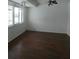 Spacious living room with hardwood floors and a light ceiling fan at 1717 Alton Rd, Port Charlotte, FL 33952
