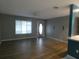 Open-concept living room features a blend of tile and wood flooring and a ceiling fan at 1717 Alton Rd, Port Charlotte, FL 33952