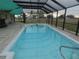 A sparkling pool with a screened enclosure is perfect for year-round enjoyment and relaxation at 1717 Alton Rd, Port Charlotte, FL 33952