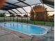 The sparkling screened-in pool provides a refreshing escape with a view of the manicured backyard at 1717 Alton Rd, Port Charlotte, FL 33952