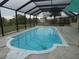 Screened-in pool with patio area and water features at 1717 Alton Rd, Port Charlotte, FL 33952