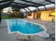 Outdoor pool with a screened enclosure, providing a comfortable and private swimming experience at 1717 Alton Rd, Port Charlotte, FL 33952