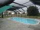 Relaxing screened-in pool area offers a refreshing escape and a tranquil backyard view at 1717 Alton Rd, Port Charlotte, FL 33952