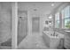 Modern bathroom with a standalone tub, a walk-in shower, and dual sinks at 17703 Savory Mist Cir, Bradenton, FL 34211