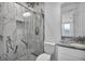Modern bathroom features a glass enclosed shower and a granite topped vanity at 17703 Savory Mist Cir, Bradenton, FL 34211