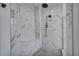 Modern bathroom featuring a spacious walk-in shower with rain shower head and pebble floor at 17703 Savory Mist Cir, Bradenton, FL 34211
