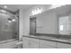 Modern bathroom with double granite vanity and large shower at 17703 Savory Mist Cir, Bradenton, FL 34211
