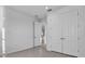 A clean and bright bedroom featuring a double door closet with stylish hardware at 17703 Savory Mist Cir, Bradenton, FL 34211