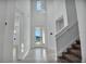 Bright foyer with soaring ceilings, modern light fixture, tile flooring, and staircase at 17703 Savory Mist Cir, Bradenton, FL 34211