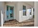 Inviting front entrance with a turquoise door, brick walkway, and modern windows at 17703 Savory Mist Cir, Bradenton, FL 34211
