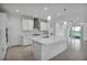 Open-concept kitchen with a spacious island, modern fixtures, and scenic water views at 17703 Savory Mist Cir, Bradenton, FL 34211