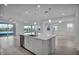 Open-concept kitchen with an island, stainless steel appliances, and water views at 17703 Savory Mist Cir, Bradenton, FL 34211