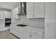 Modern kitchen features stainless steel appliances and white cabinets at 17703 Savory Mist Cir, Bradenton, FL 34211