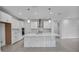 A modern kitchen featuring white cabinetry, stainless steel appliances, and a kitchen island at 17703 Savory Mist Cir, Bradenton, FL 34211