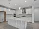 Modern kitchen featuring a large island with white countertops, stainless steel appliances, and stylish backsplash at 17703 Savory Mist Cir, Bradenton, FL 34211