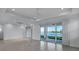 Bright and open living room with tile flooring and sliding doors with views of the lake at 17703 Savory Mist Cir, Bradenton, FL 34211