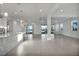 Expansive living room features tile flooring, modern lighting, and beautiful water views at 17703 Savory Mist Cir, Bradenton, FL 34211