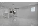 Open-concept living area showcasing modern tile floors and seamlessly flowing kitchen at 17703 Savory Mist Cir, Bradenton, FL 34211
