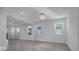 Living room features a contemporary chandelier and multiple windows at 17703 Savory Mist Cir, Bradenton, FL 34211