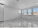 Bright living room featuring large windows and stylish tile flooring throughout at 17703 Savory Mist Cir, Bradenton, FL 34211