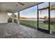 Large screened patio with brick flooring and a beautiful water view at 17703 Savory Mist Cir, Bradenton, FL 34211