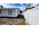 Backyard with view of side of house and fence at 2109 19Th W St, Bradenton, FL 34205