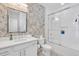 Bathroom with a large mirror, sink, toilet, walk-in shower, and neutral-toned wallpaper at 2283 Arlington St, Sarasota, FL 34239