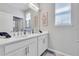 Bright bathroom with double sinks, framed nautical decor, and a window for natural light at 2283 Arlington St, Sarasota, FL 34239