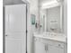 Well-lit half bathroom featuring a modern vanity, stylish mirror, and coastal-themed decor at 2283 Arlington St, Sarasota, FL 34239