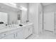 Bright bathroom featuring a double vanity with undermount sinks and modern fixtures at 2283 Arlington St, Sarasota, FL 34239