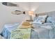 Comfortable bedroom featuring light blue coral-themed bedding and decorative fish wall decor at 2283 Arlington St, Sarasota, FL 34239