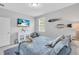 Bedroom featuring a queen bed with blue bedding, a TV, a dresser, and nautical-themed decor at 2283 Arlington St, Sarasota, FL 34239