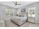 Calm bedroom featuring neutral decor, two large windows, and natural light at 2283 Arlington St, Sarasota, FL 34239