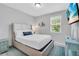 Comfortable bedroom with nautical decor, natural light and beach themed TV at 2283 Arlington St, Sarasota, FL 34239