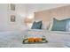 Bright, cozy bedroom featuring a queen bed with a gray headboard and turquoise accents at 2283 Arlington St, Sarasota, FL 34239